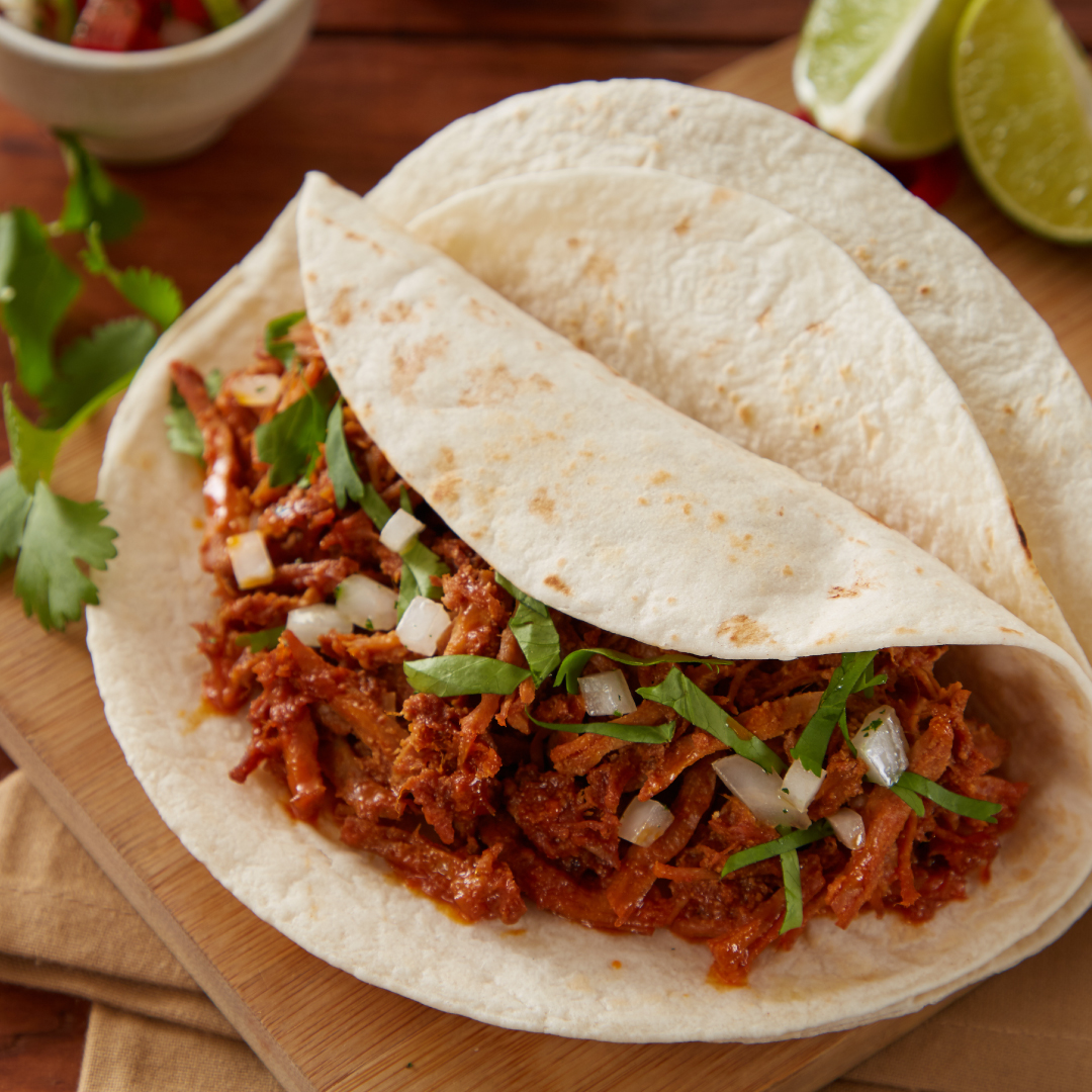 Lifestyle moment of prepare food ready to eat a taco of Chilorio Pork